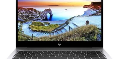 HP laptop showing scenic landscape with ocean and cliffs, ideal for website design and IT services.